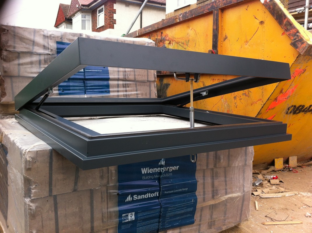 Opening flat roof skylight in anthracite grey installed in Iver