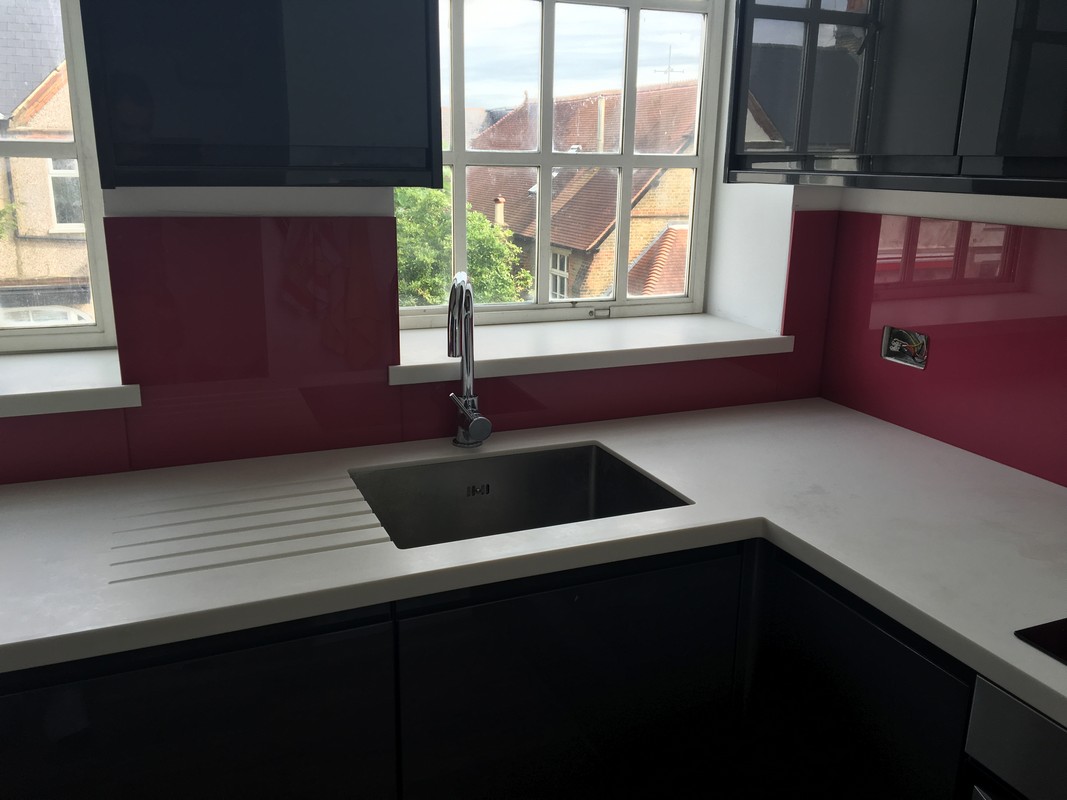 Deep plum coloured glass splashback in modern Iver kitchen